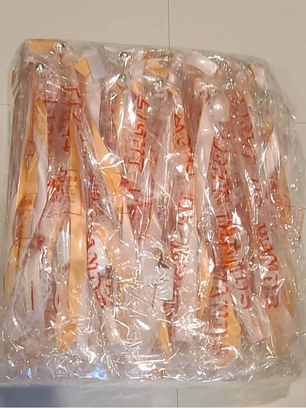 50 individually wrapped LED wands with Champagne ribbon and white lace with bell